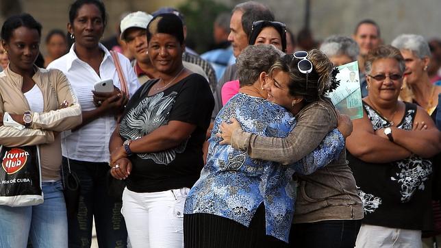 Dos mujeres se abrazan después de que una de ellas consiguiera visado para EE.UU., este martes en La Habana