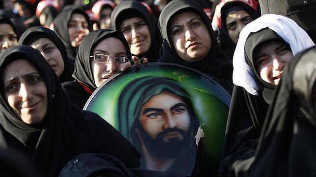Mujeres chiíes en Estambul durante una fiesta religiosa con una imagen del imán«mártir» Husein, nieto de Mahoma