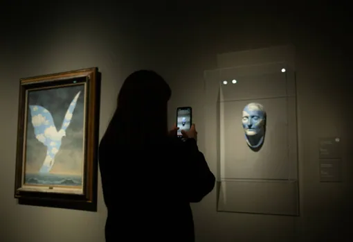 A visitor takes a photo of 'The future of sculptures'