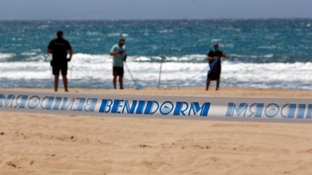 Operarios del Ayuntamiento señalizandno las zonas de uso en la playa de Benidorm