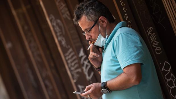 Un hombre fuma en las calles de Valencia