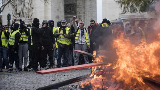 Fotografía de archivo de un grupo de chalecos amarillos manifestándose y haciendo una barricada