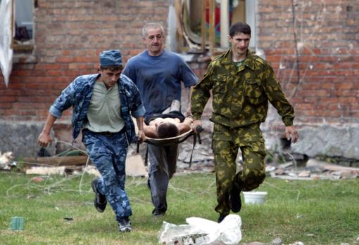 Beslan terrorist attack. A boy is rescued from the attacked school