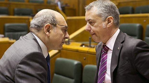 El lendakari, Iñigo Urkullu, y el consejero vasco de Salud, Jon Darpón, conversan al comienzo del pleno del Parlamento Vasco que aprobó la ley de Adicciones y Drogodependencias
